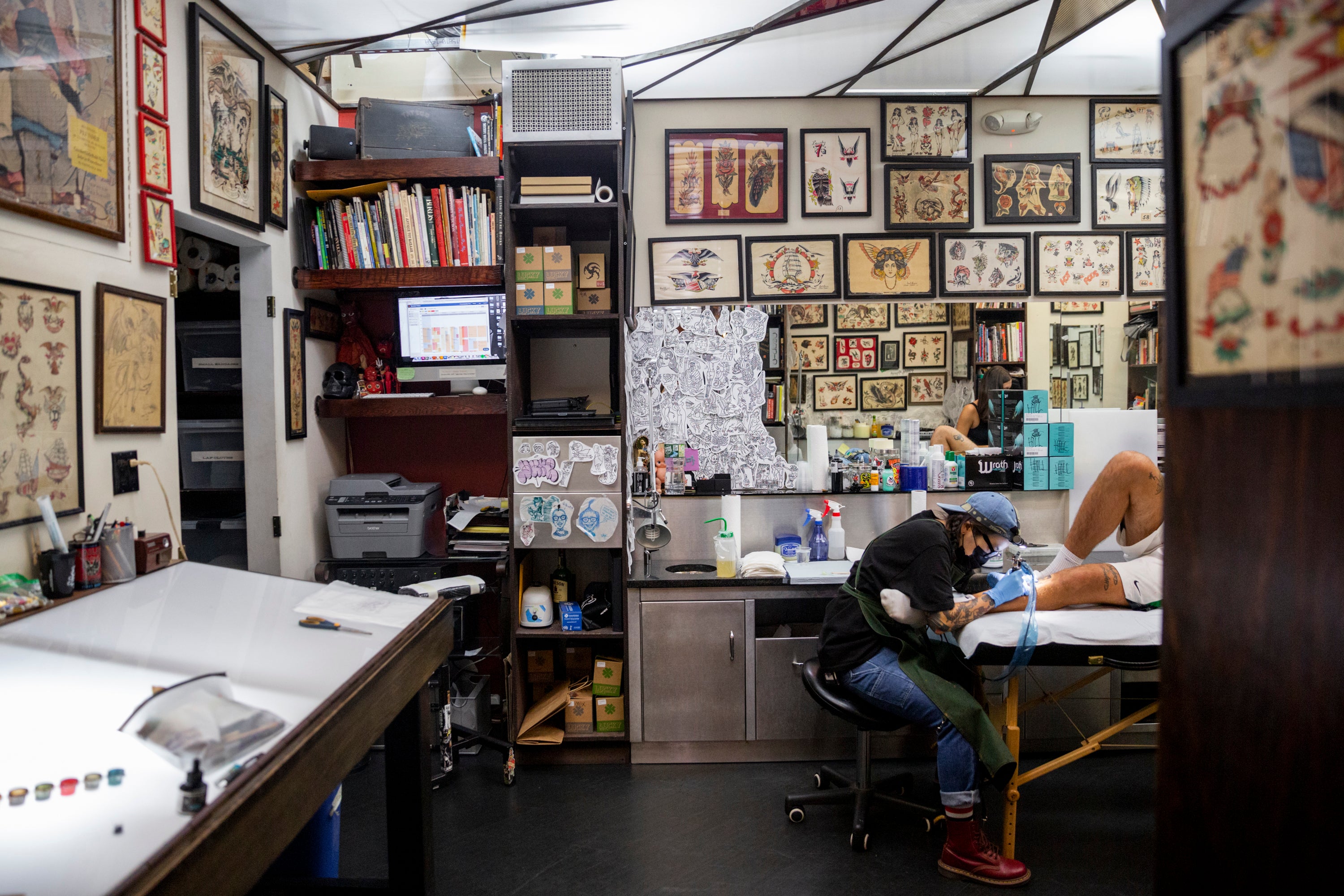 Yoon Park, a tattoo artist at Daredevil Tattoo, works on a client’s leg