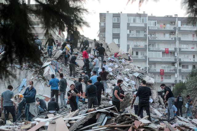 Volunteers clear rubble in Izmir  (Photo by MERT CAKIR/AFP via Getty Images)