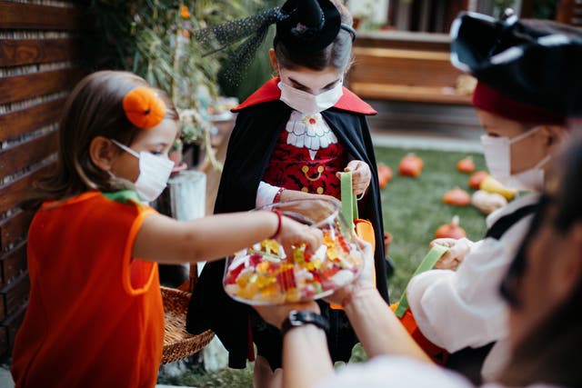 <p>Group of children trick or treating during the Covid-19 pandemic </p>