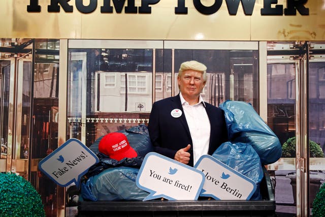 <p>A wax figure depicting U.S. President Donald Trump is put into a dumpster at Madame Tussauds in Berlin, Germany, on 30 October2020</p>