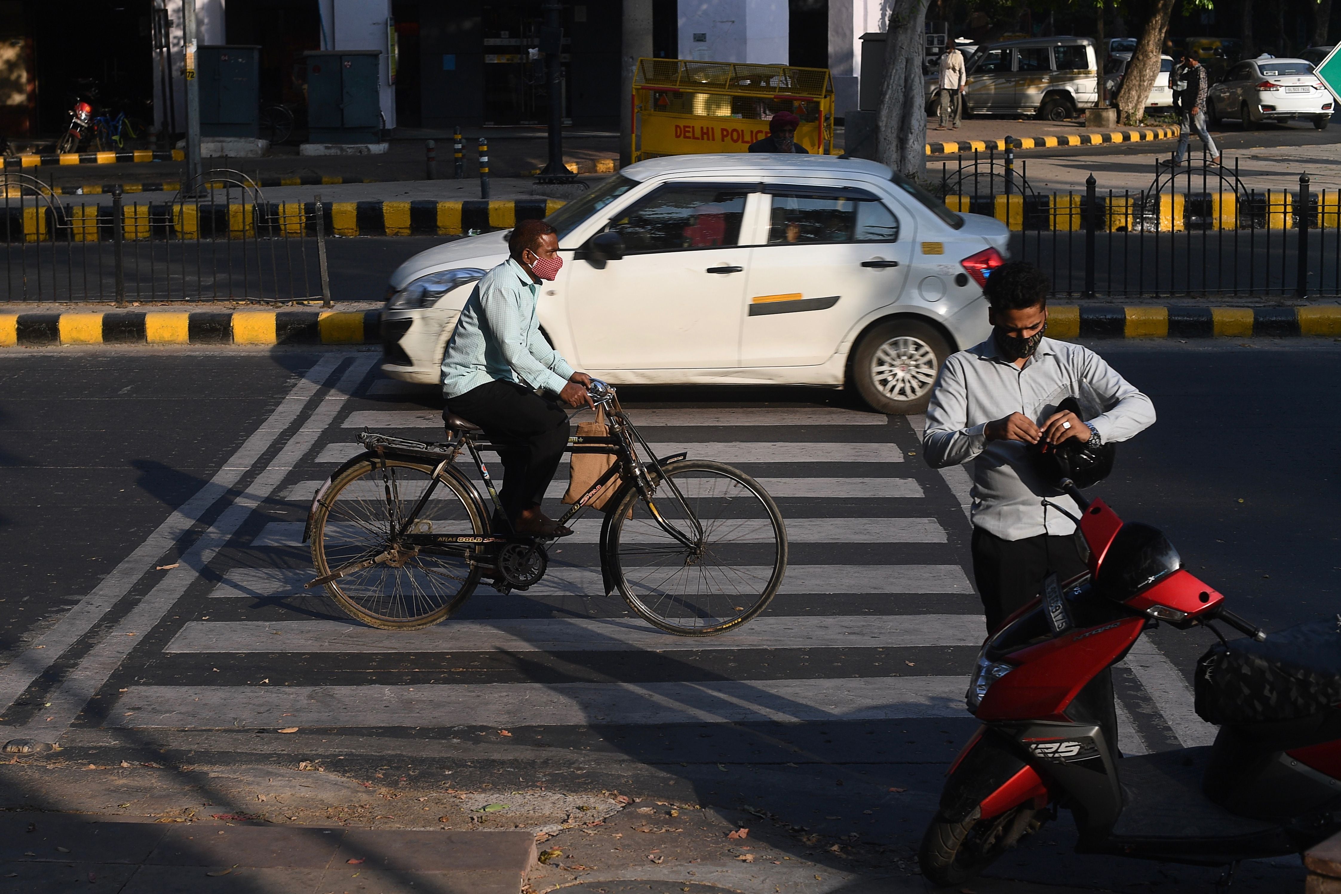 Pedestrians cross the road in New Delhi