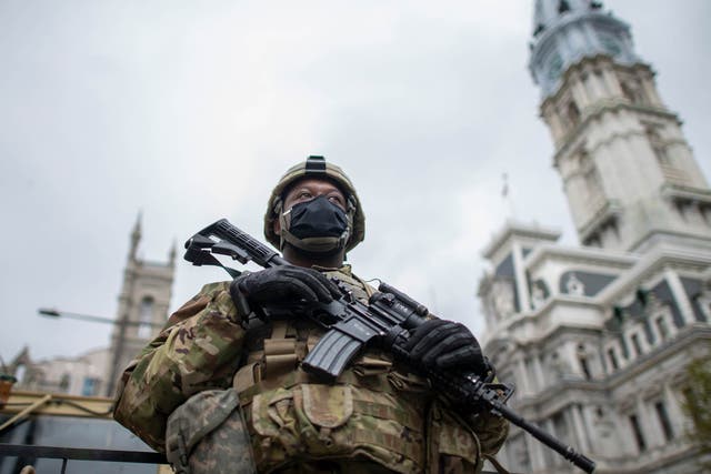 <p>National Guard member patrols the area around Philadelphia City Hall on 30 October</p>