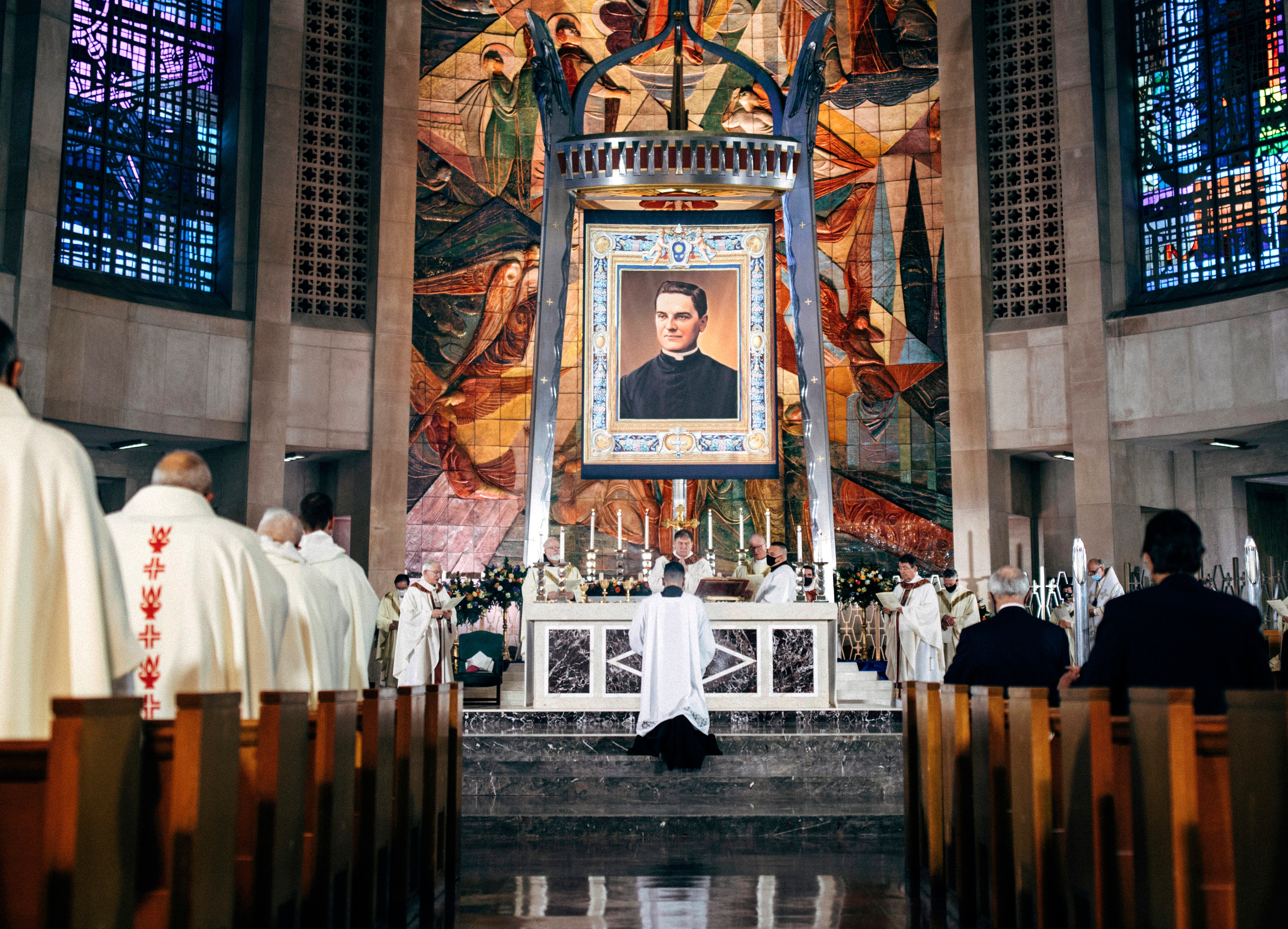 In this photo provided by the Archdiocese of Hartford, a tapestry showing Rev. Michael McGivney hangs above the alter at the Cathedral of St. Joseph in Hartford, Conn, Saturday, Oct. 31, 2020. The late Connecticut priest who founded the Knights of Columbus moved a step closer to possible sainthood with his beatification Saturday, as authorized by Pope Francis. (Archdiocese of Hartford via AP)