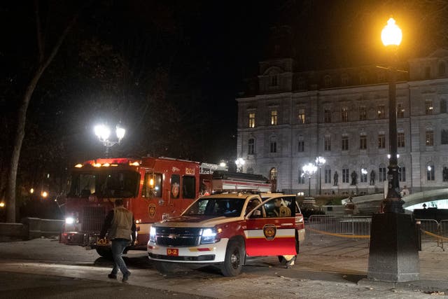 <p>First responder trucks block the front of the National Assembly in the early hours of Sunday</p>