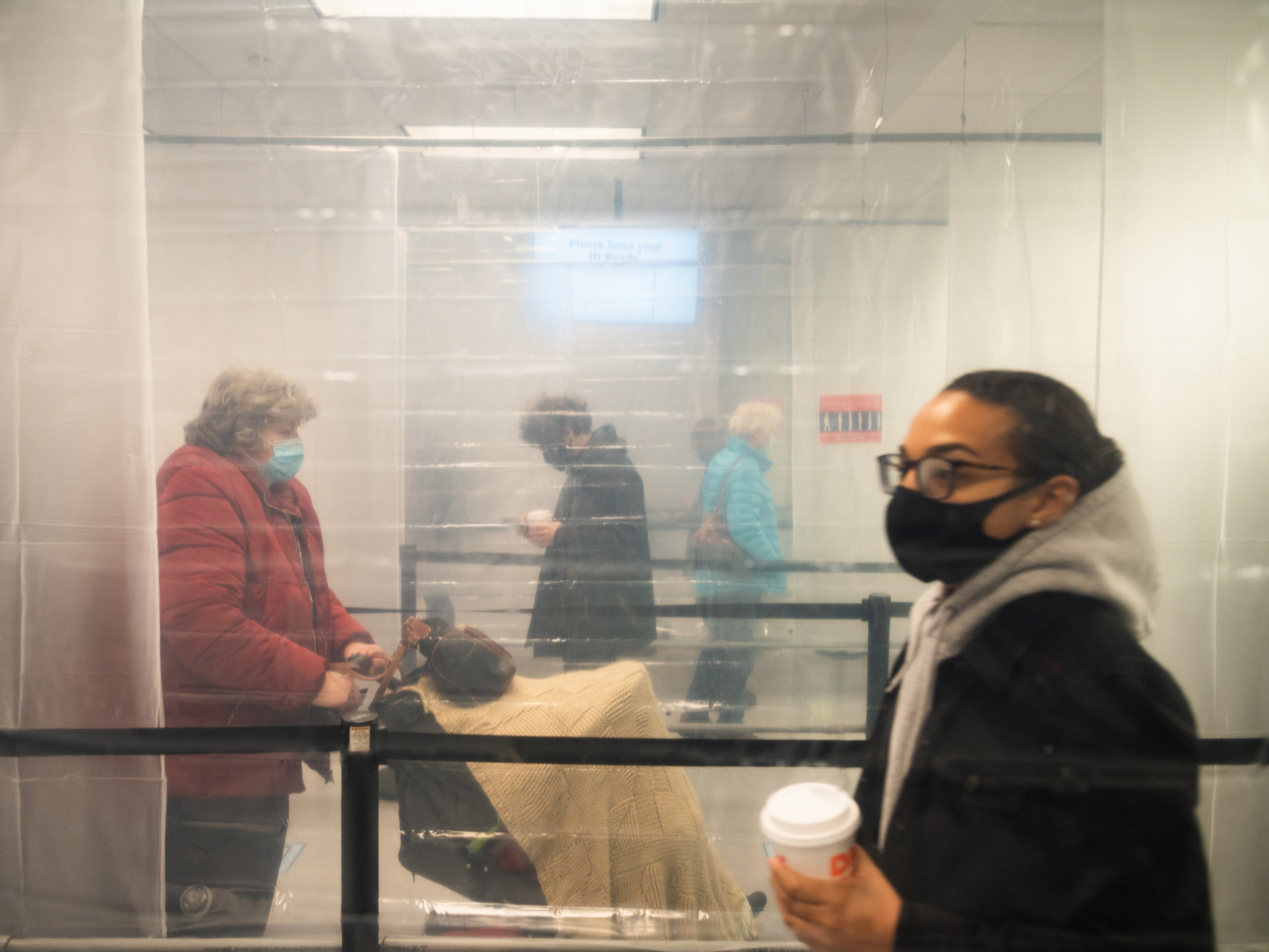 Plastic sheeting helps keep voters separated during early voting at the Cuyahoga County Board of Elections in Cleveland