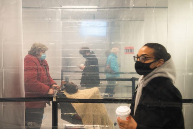 Plastic sheeting helps keep voters separated during early voting at the Cuyahoga County Board of Elections in Cleveland