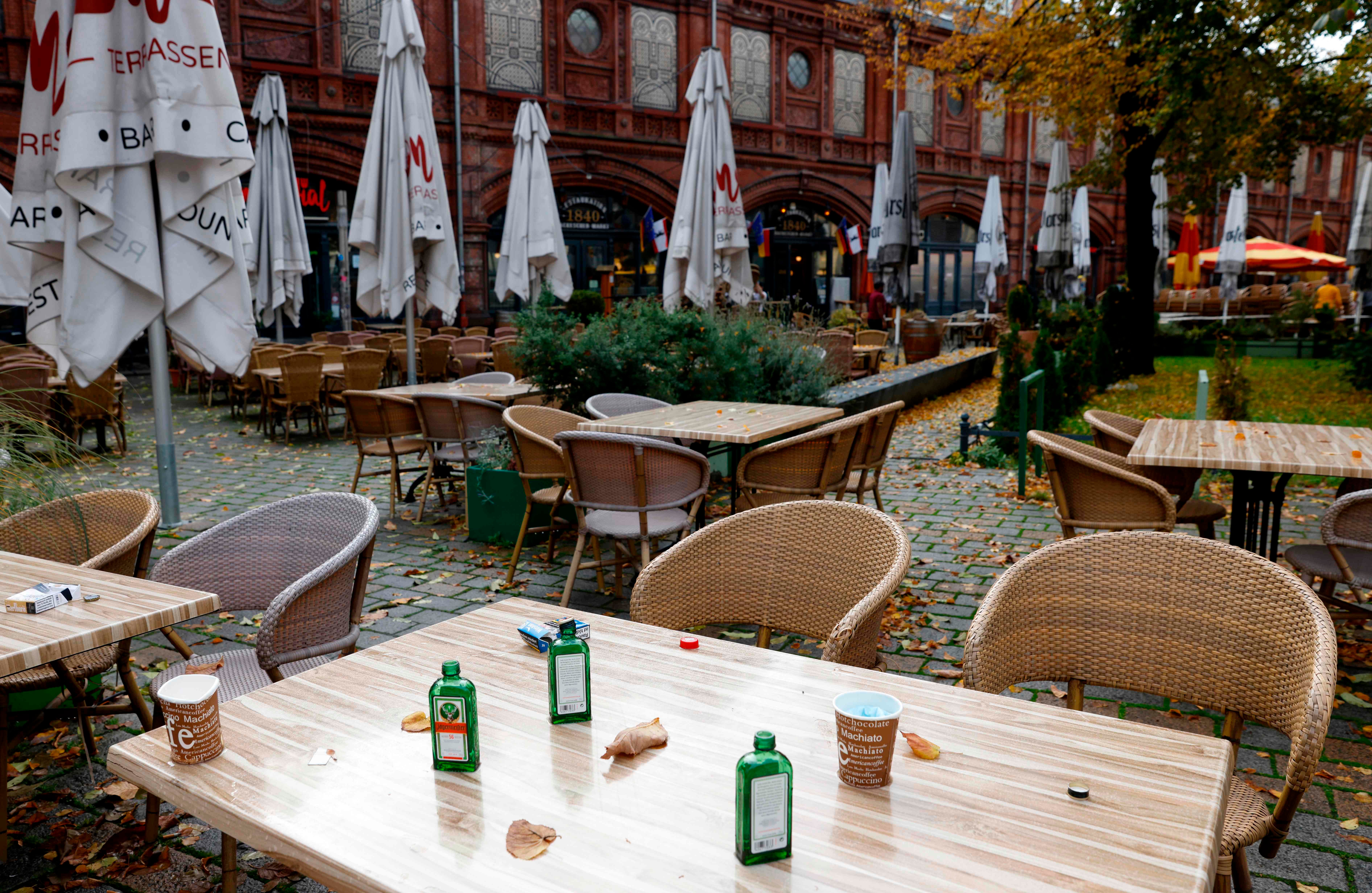 The remains of the last party are seen on the table of a closed cafe at Berlin's Hackescher Markt