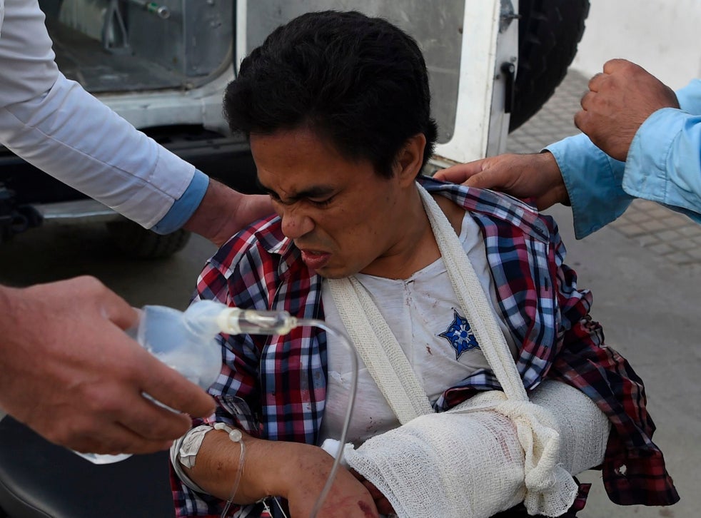 A man wounded in the Kabul University attack arrives at Isteqlal Hospital