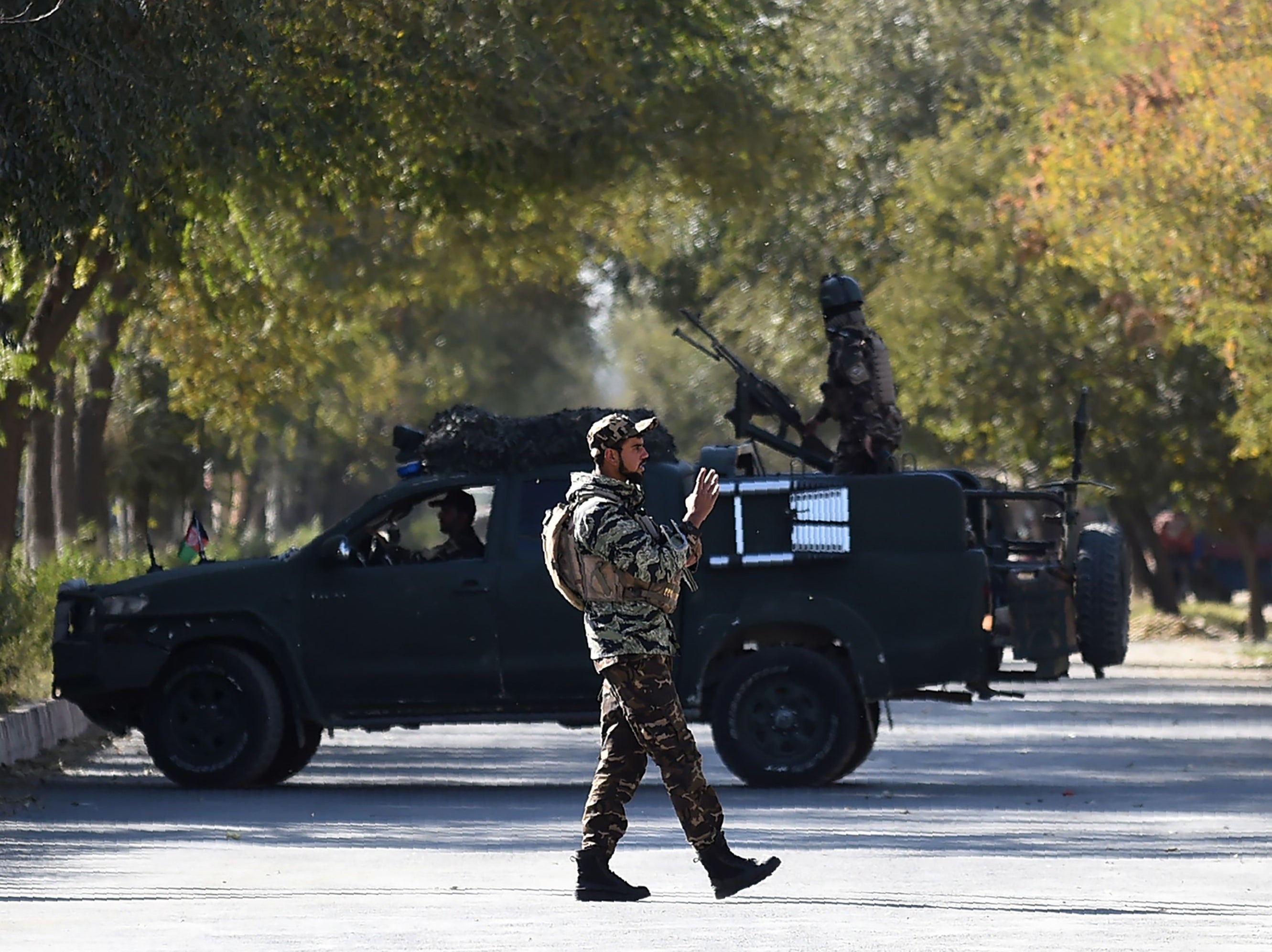 Armed security personnel stand guard outside Kabul University