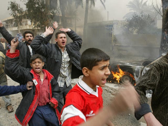 Iraqis in the street after an airstrike in Baghdad on 26 March 2003