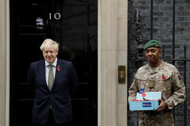 Prime minister Boris Johnson buys a Royal British Legion poppy ahead of Remembrance Sunday
