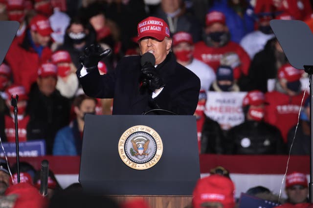 <p>President Donald Trump speaks to supporters during a campaign rally at the Kenosha Regional Airport using a hand-held microphone. (Photo by Scott Olson/Getty Images)</p>