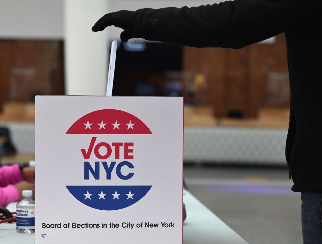 A voter drops off her early ballot at the Brooklyn Museum