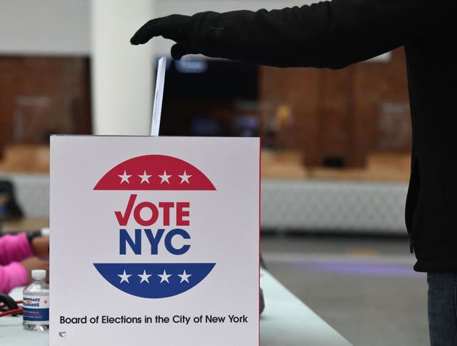 <p>A voter drops off her early ballot at the Brooklyn Museum</p>