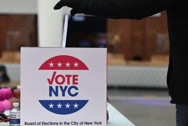 <p>A voter drops off her early ballot at the Brooklyn Museum</p>