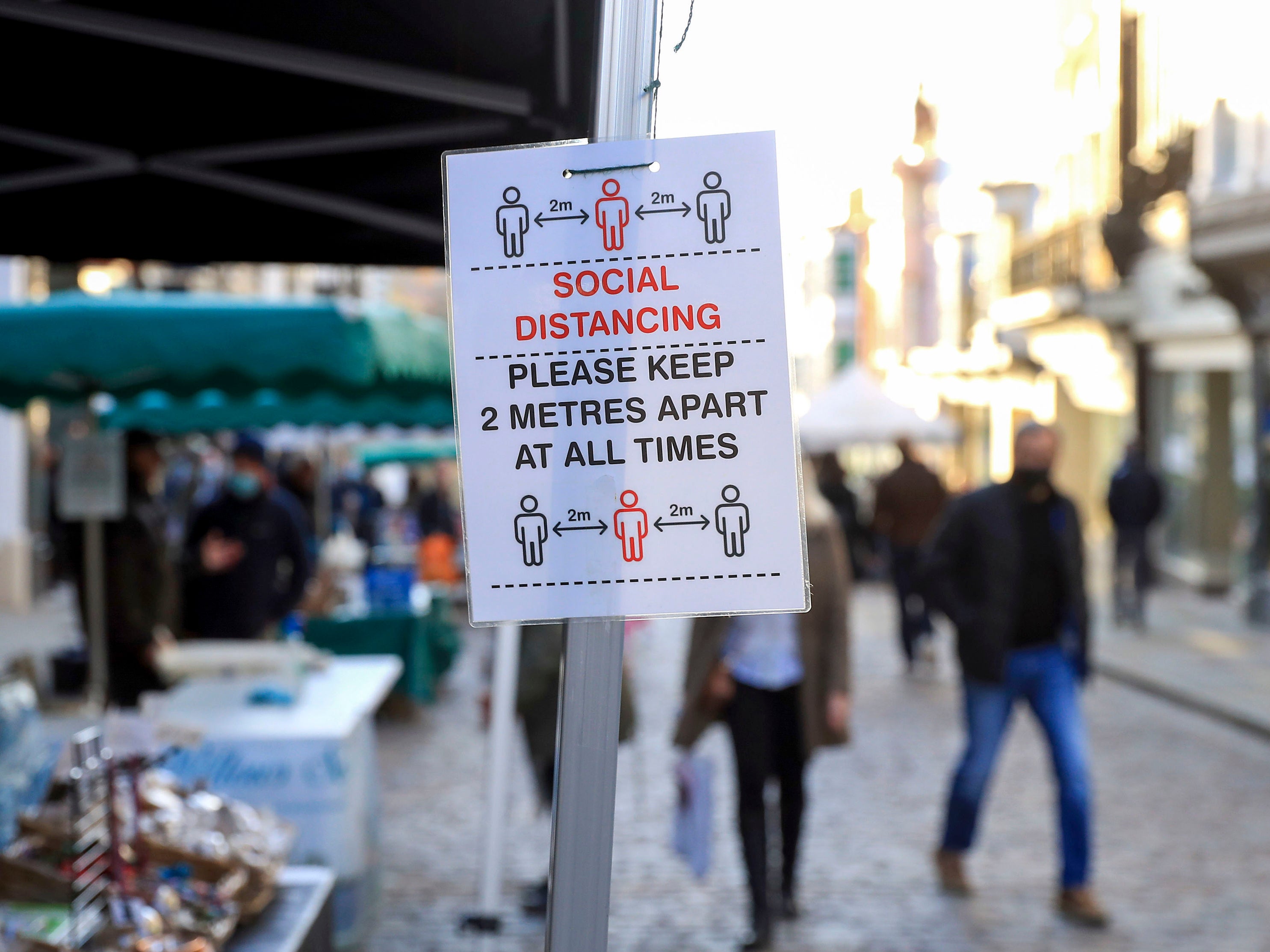 A sign in Guildford, Surrey, informing market visitors to social distance, ahead of a national lockdown for England from Thursday