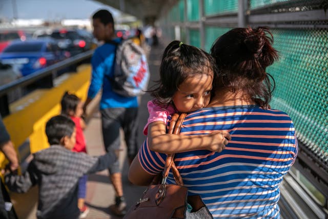 A family of Mexican asylum seekers walks to the center of the international bridge between Mexico and the United States to officially request political asylum from U.S. immigration officials on December 08, 2019 in the Mexican border town of Matamoros, Mexico. Under the Trump administration’s Migrant Protection Protocols, tens of thousands of asylum seekers have been forced to wait in Mexico while their immigration claims are processed in the U.S.