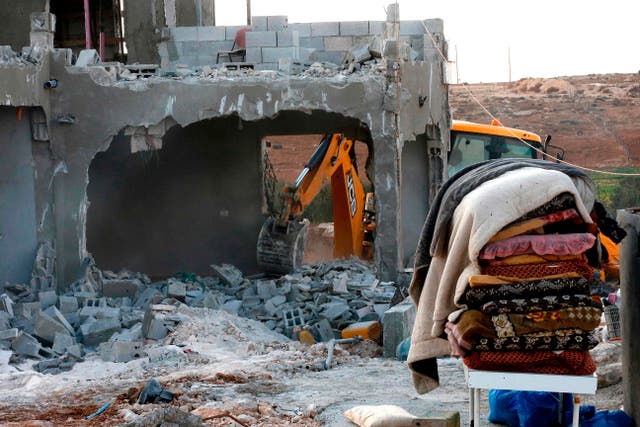 <p>Israeli machinery demolishes a Palestinian house near Yatta, in the southern area of the West Bank town of Hebron, on 2 November 2 2020</p>
