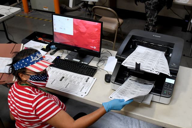 <p>A Clark County election worker scans mail-in ballots at the Clark County Election Department on in North Las Vegas, Nevada</p>