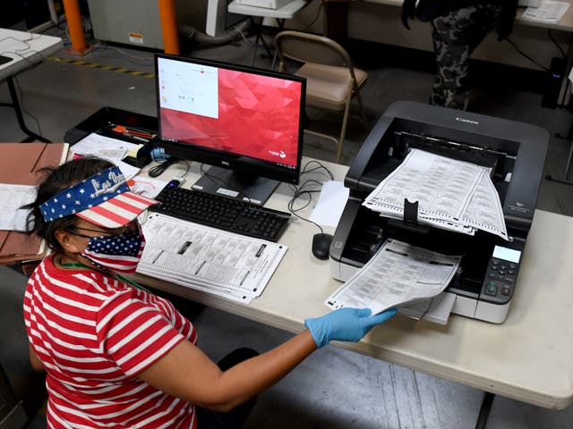 <p>A Clark County election worker scans mail ballots at the Clark County Election Department on in North Las Vegas, Nevada</p>