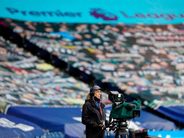 Premier League camerawoman watches on