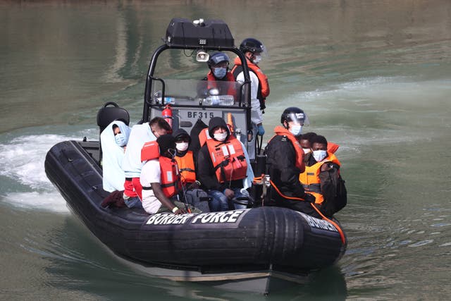 <p>A Border Force patrol with migrants from a small boat in the Channel</p>