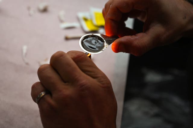 Drug users prepare heroin inside of a Safe Consumption van set up by Peter Krykant on September 25, 2020 in Glasgow, Scotland. A North Carolina mother has been charged with murder in the death of her 14-year-old daughter, who overdosed.