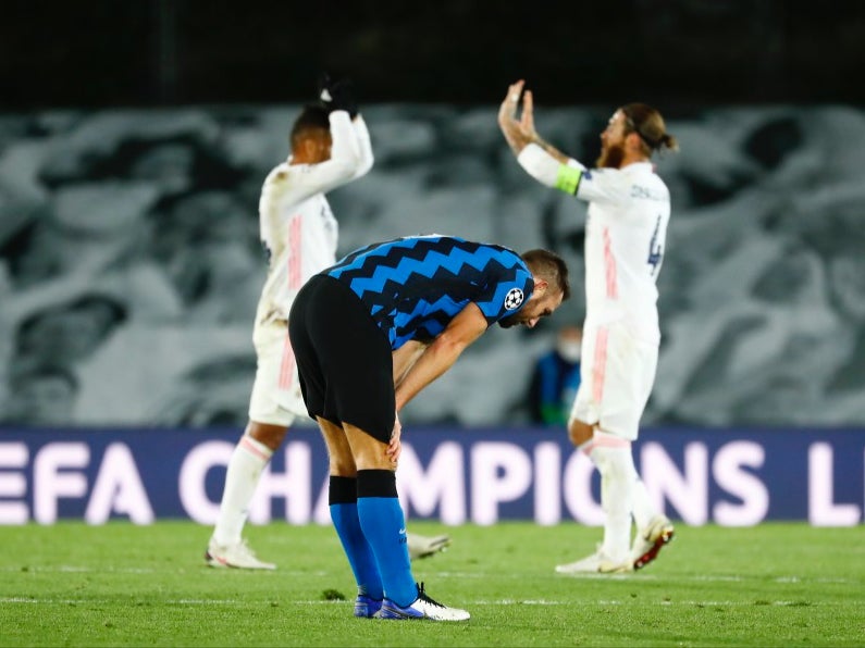 Stefan de Vrij looks dejected while Sergio Ramos and Casemiro celebrate