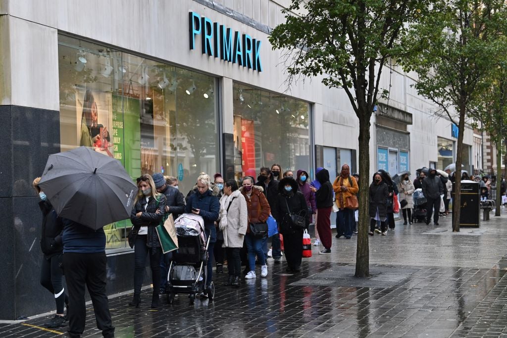 Shoppers queue outside a Primark store in Liverpool before lockdown