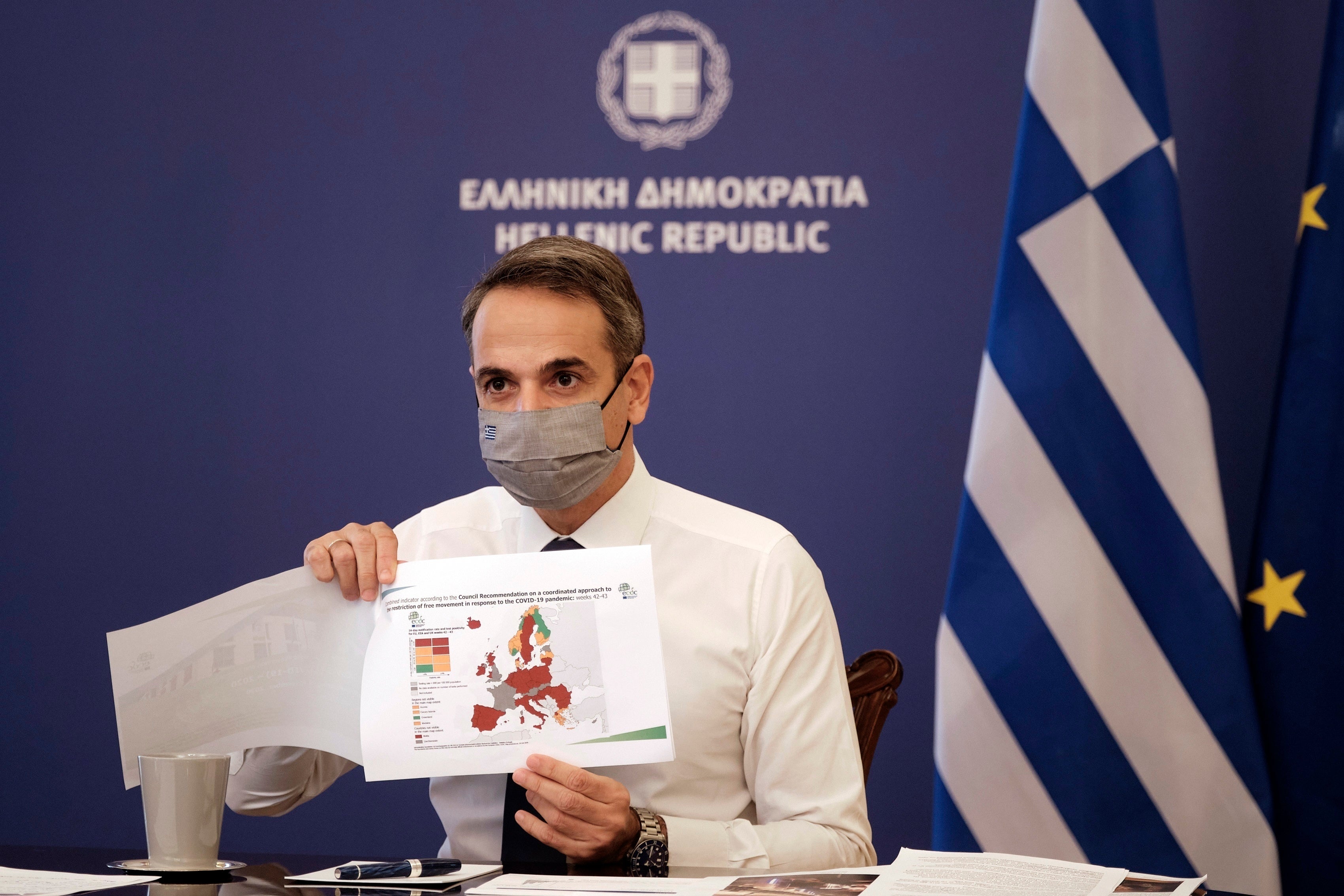 Greece’s prime minister Kyriakos Mitsotakis shows a map of Europe during his announcement on the country’s new lockdown