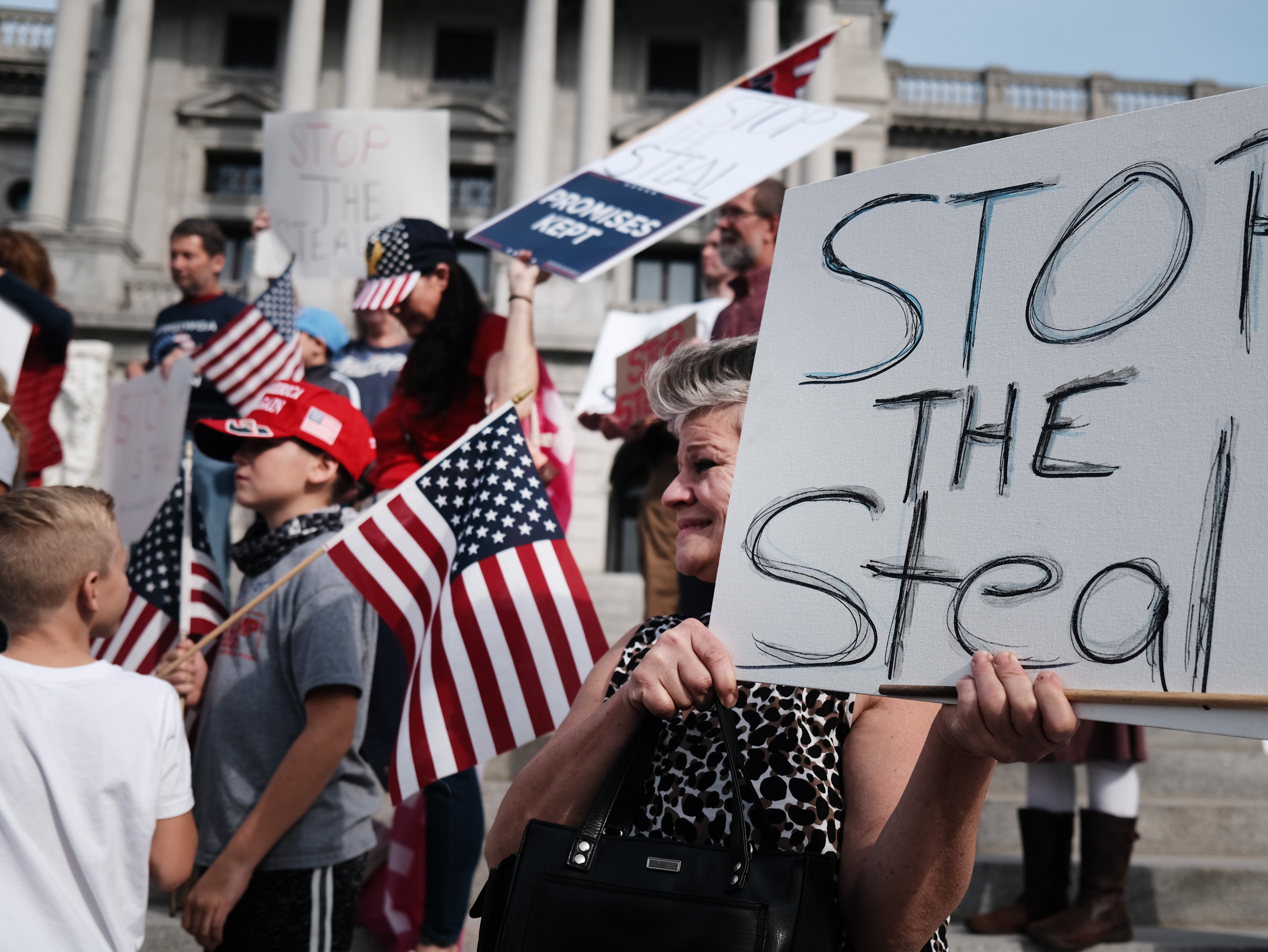 Dozens of people calling for stopping the vote count in Pennsylvania due to alleged fraud against President Donald Trump gather on the steps of the State Capital on 5 November 2020 in Harrisburg, Pennsylvania