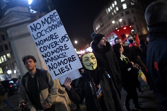 An anti-lockdown protester wears a Guy Fawkes mask in Trafalgar Square