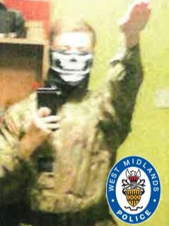 Paul Dunleavy performing a Hitler salute and wearing combat fatigues