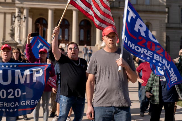 Trump supporters demonstrating the election results face off with counter protesters at the State Capitol in Lansing, Michigan