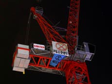 Teenage protester who climbed crane is ‘cold but in good health’