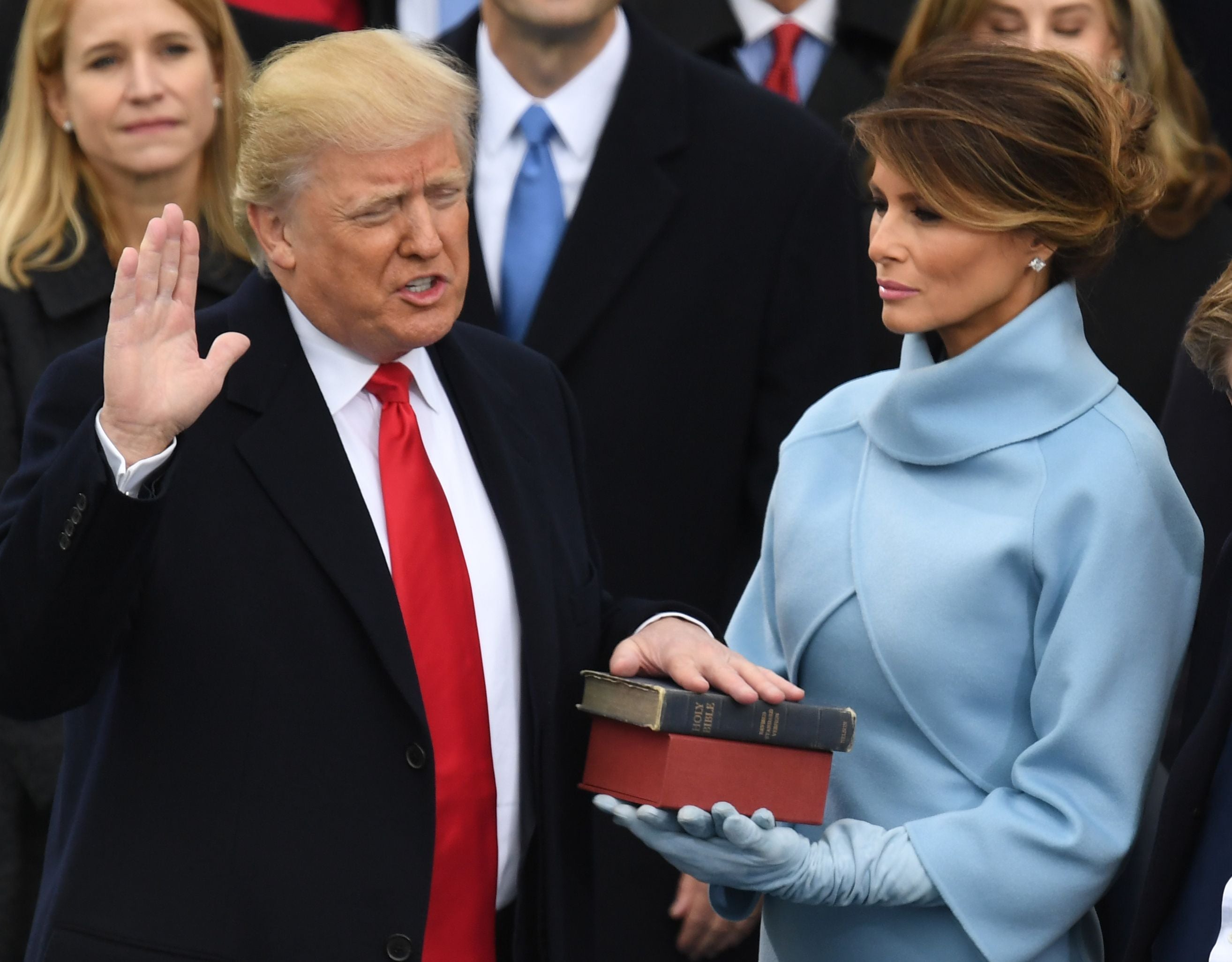 Melania Trump holds the Bible as her husband Donald Trump is sworn in as president on 20 January, 2016 (Photo by Mark RALSTON / AFP) (Photo by MARK RALSTON/AFP via Getty Images)