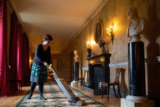 A staff member cleans the carpet at the National Trust’s Mottisfont Abbey in Hampshire