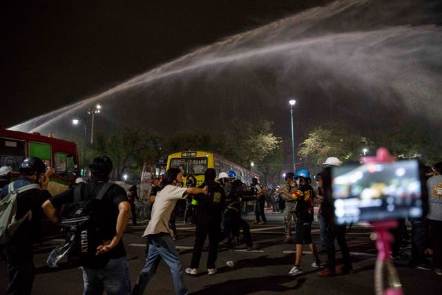 Thai police fires water cannons on pro-democracy protesters and student activists during a march in Bangkok on Sunday