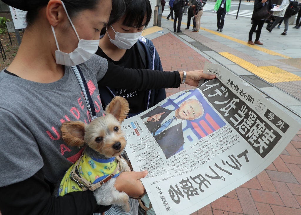 Japanese residents read about Joe Biden’s historic win in the presidential election