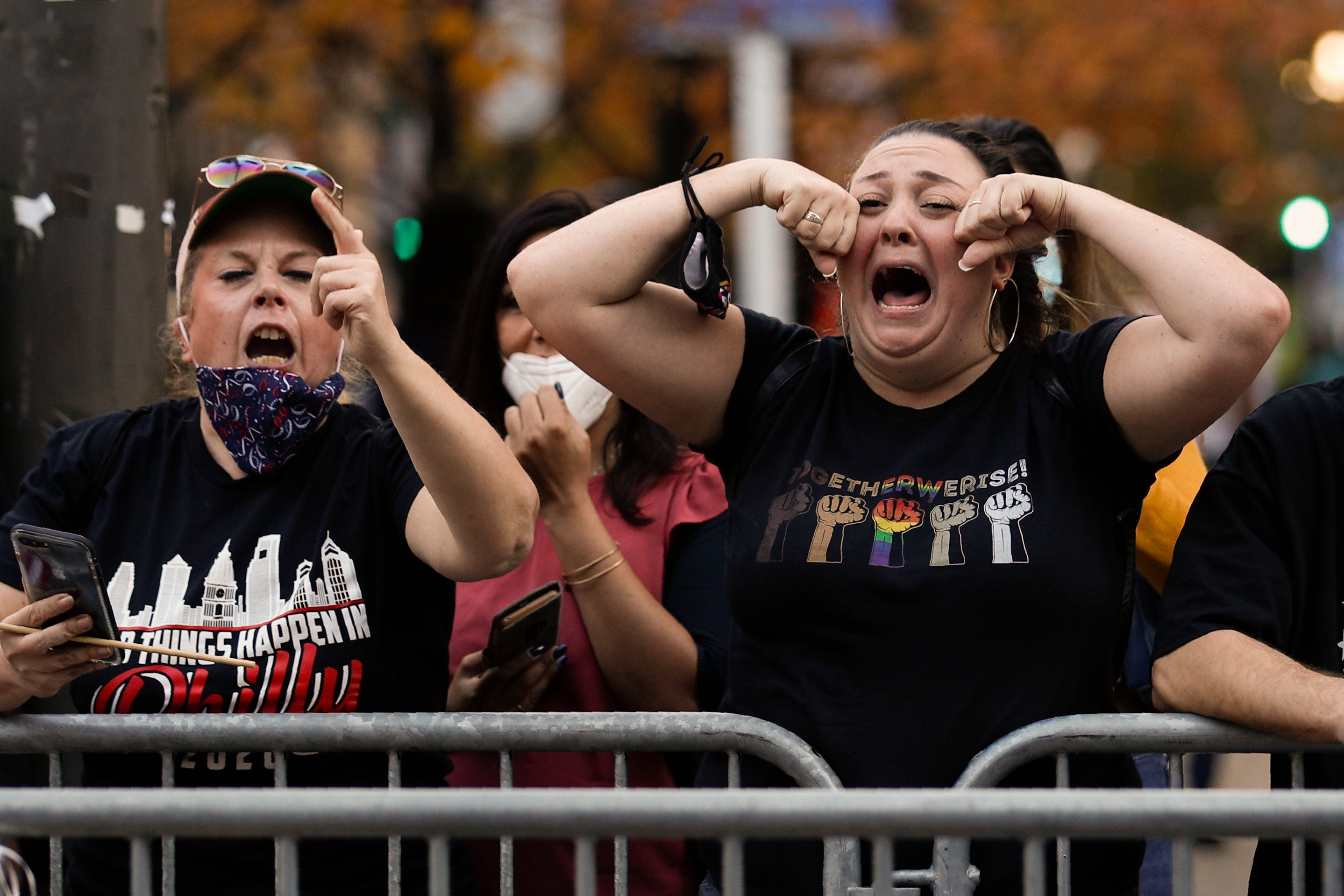 Joe Biden fans taunt Trump supporters in Washington, but the outgoing president could make moves which appeal to his base before he leaves office (AP Photo/Rebecca Blackwell)