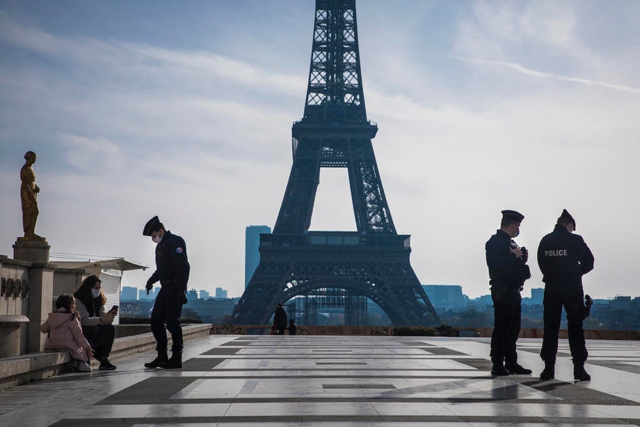 French Police officers patrol the deserted Trocadero square near the Eiffel Tower during the second national lockdown