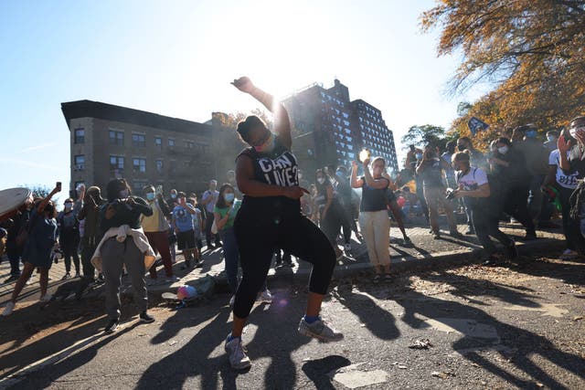 <p>People celebrate at the entrance to Prospect Park after Joe Biden was declared winner of the 2020 presidential election</p>