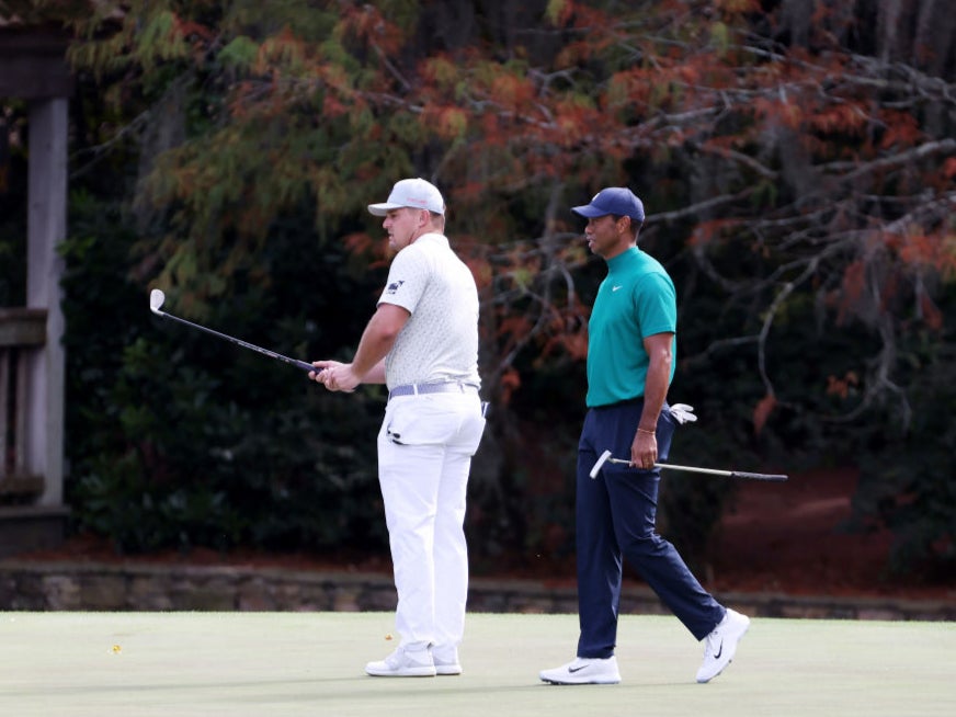 Bryson DeChambeau and Tiger Woods share the putting green at Augusta