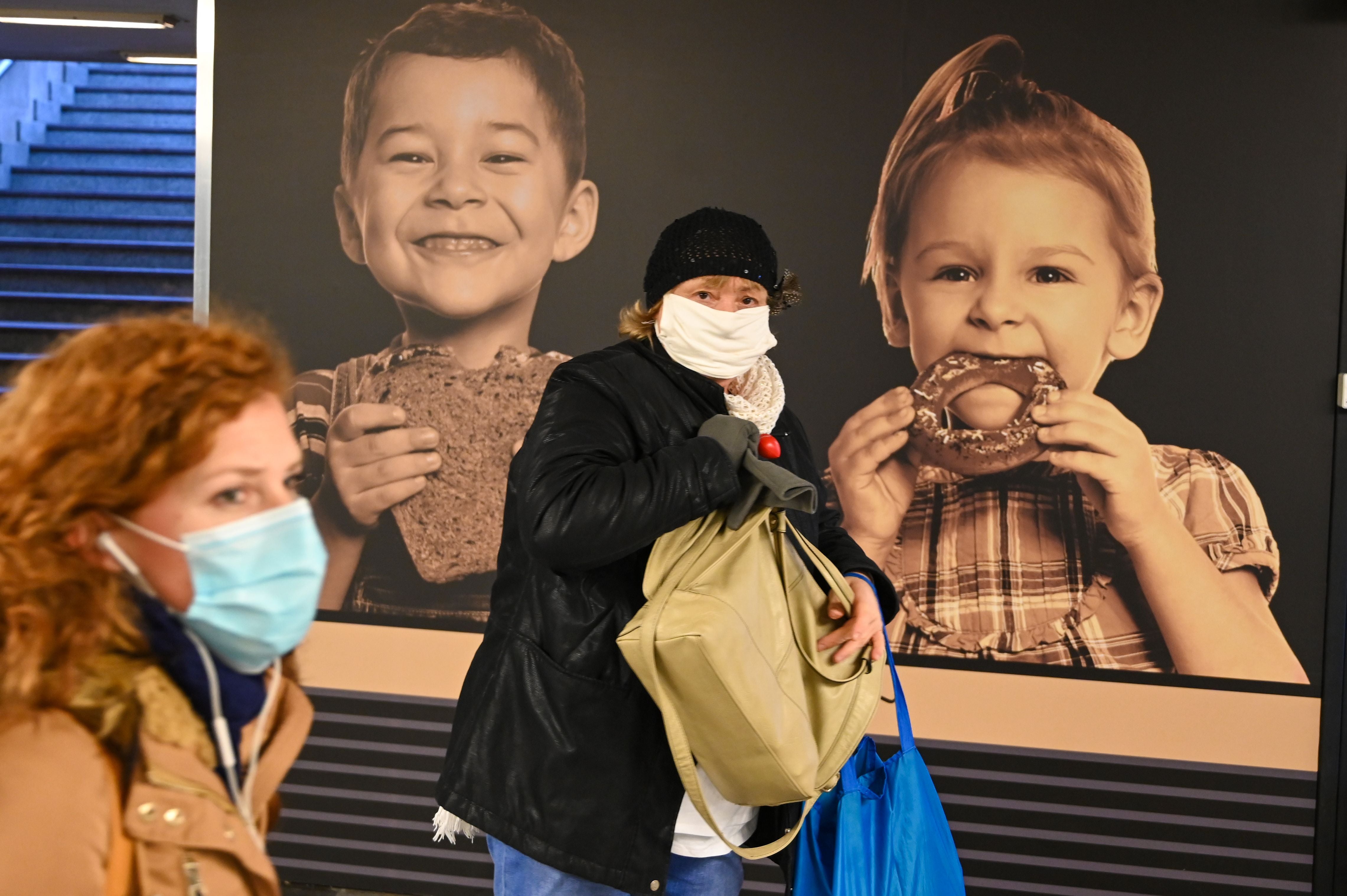 Commuters wear face masks as they walk through an underpass in Budapest on November 10, 2020, hours before as a partial lockdown comes into force