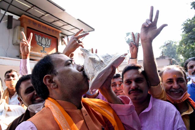 Supporters of India’s ruling BJP celebrate the lead of their party’s alliance in Bihar state elections