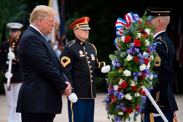 Donald Trump has continued the presidential tradition of honouring fallen US soldiers at Arlington National Cemetery on Veterans Day.