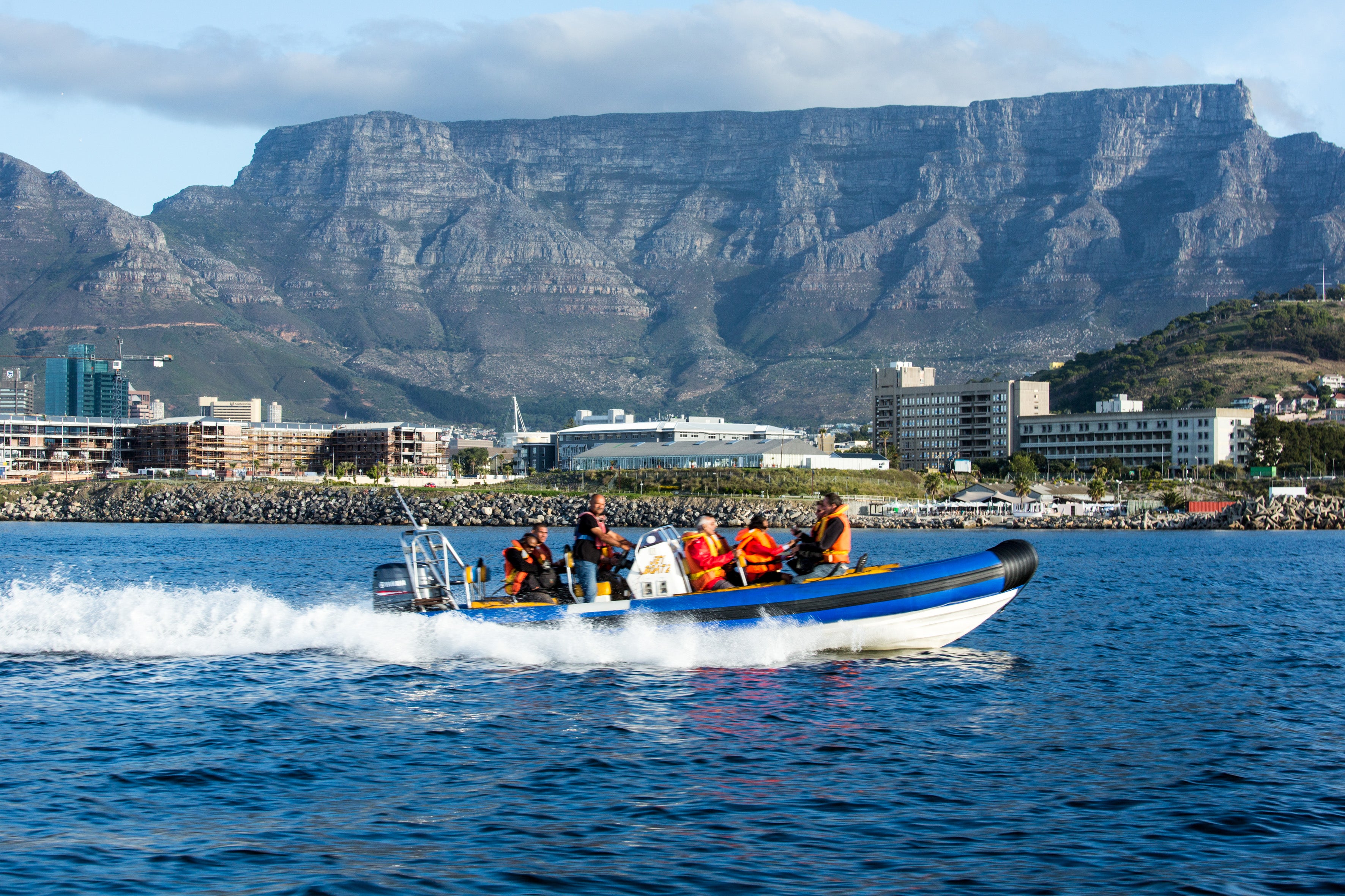 Making waves: tourists motor across the bay in Cape Town