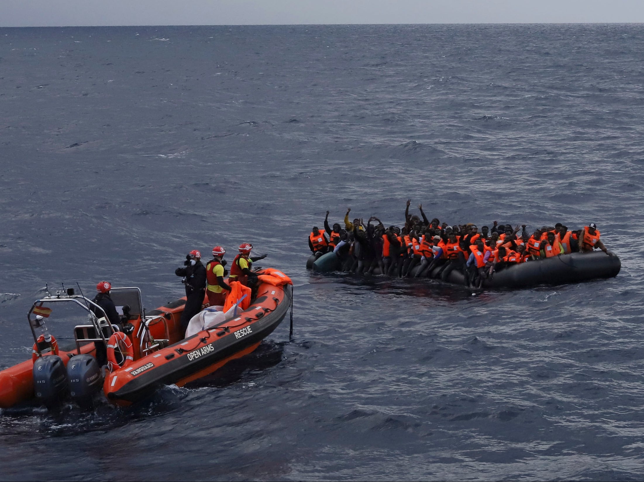 Refugees and migrants wait to be rescued by members of the Spanish NGO Proactiva Open Arms, after leaving Libya trying to reach European soil aboard an overcrowded rubber boat in the Mediterranean sea