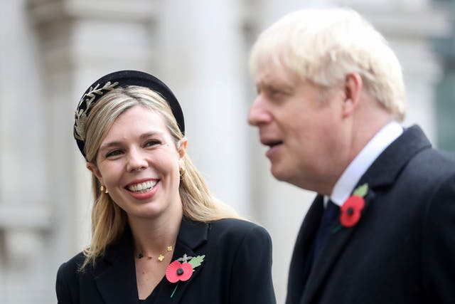 <p>Boris Johnson and his fiancée Carrie Symonds attend the Remembrance service at the Cenotaph on Sunday</p>
