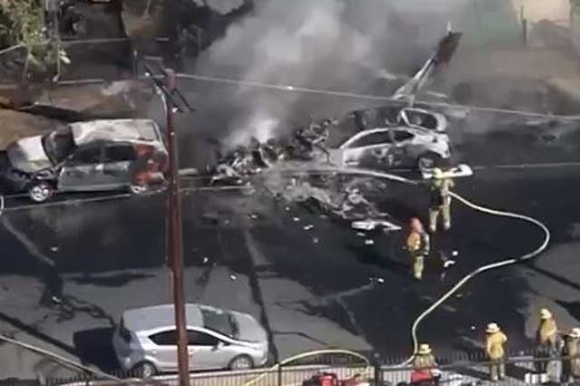 A small plane crashed into a neighborhood in the San Fernando Valley, leaving cars and a yard engulfed in flames.